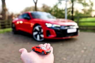 a hand holding a toy car