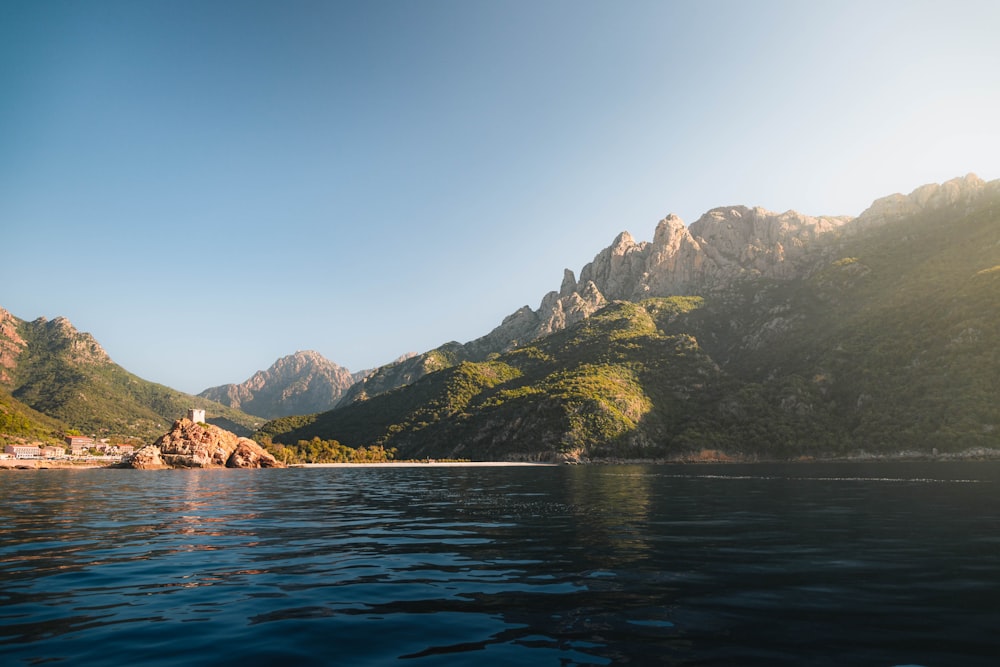 a body of water with mountains in the background