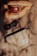 A baseball glove and ball made of handcrafted top grain cowhide lie on a wooden surface. Nearby, a pair of dark sunglasses and a beige zipper pouch with a small tag are placed. The lighting casts soft shadows, enhancing the warm tones of the objects.