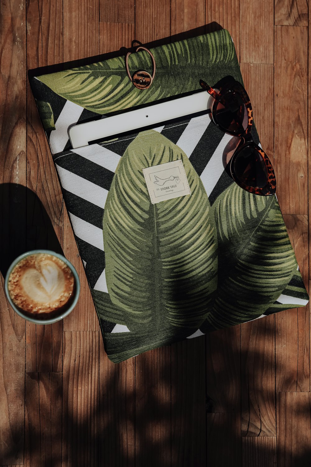 a green and white shirt on a wood surface