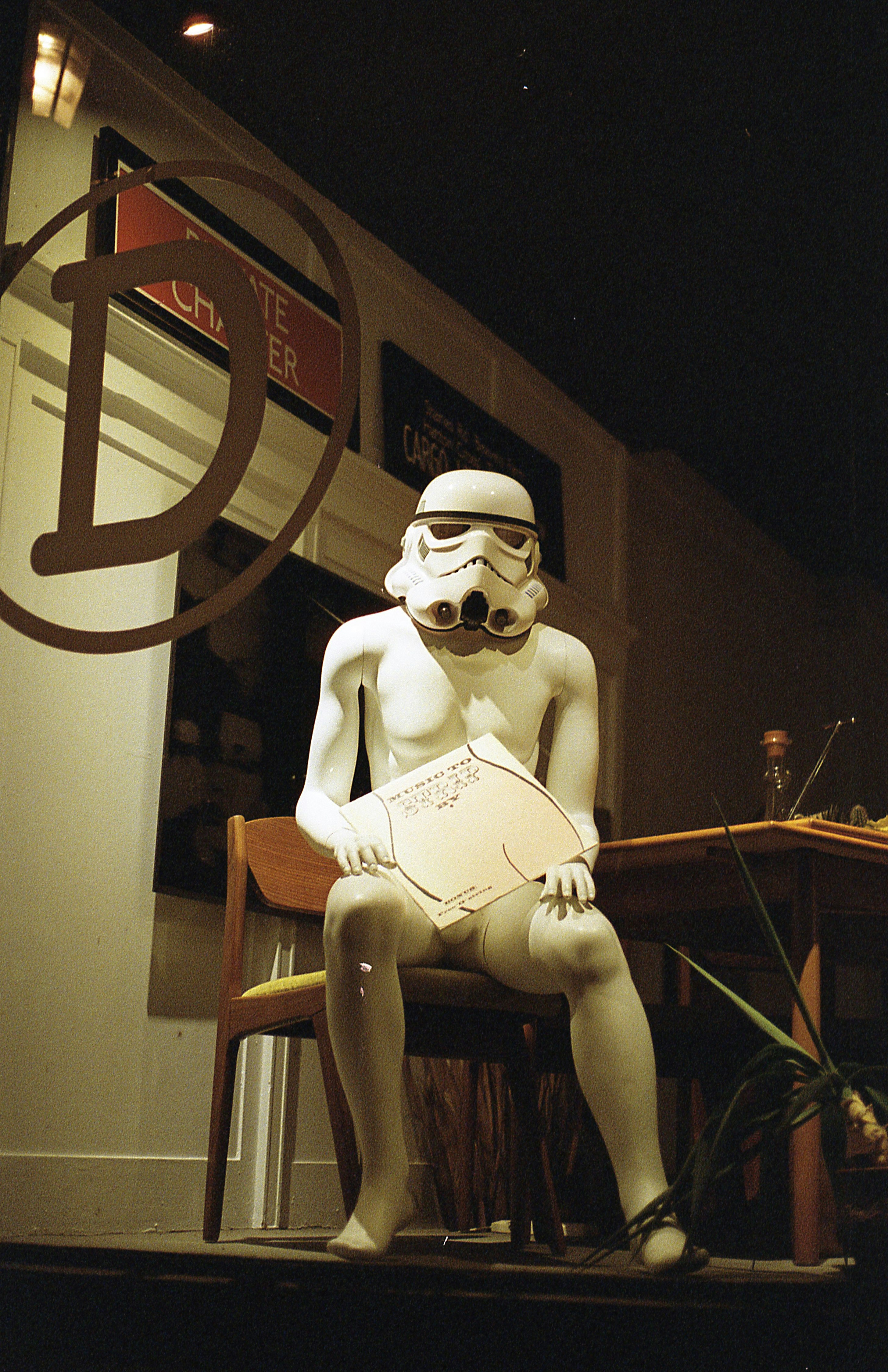 a skeleton sitting on a chair