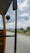 A happy customer enjoying a ride in a clean Pallavi Travels cab with a scenic view in the background.