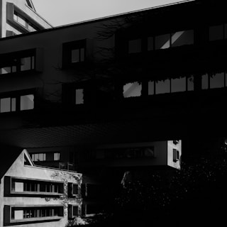 An aesthetic black-and-white photo of urban architecture blending shadows and light.