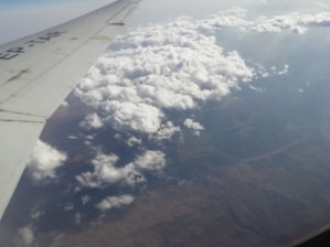 An aerial view of an airplane flying over a beautiful landscape.