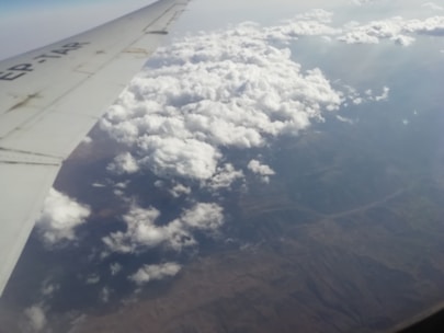 An aerial view of an airplane flying over a beautiful landscape.