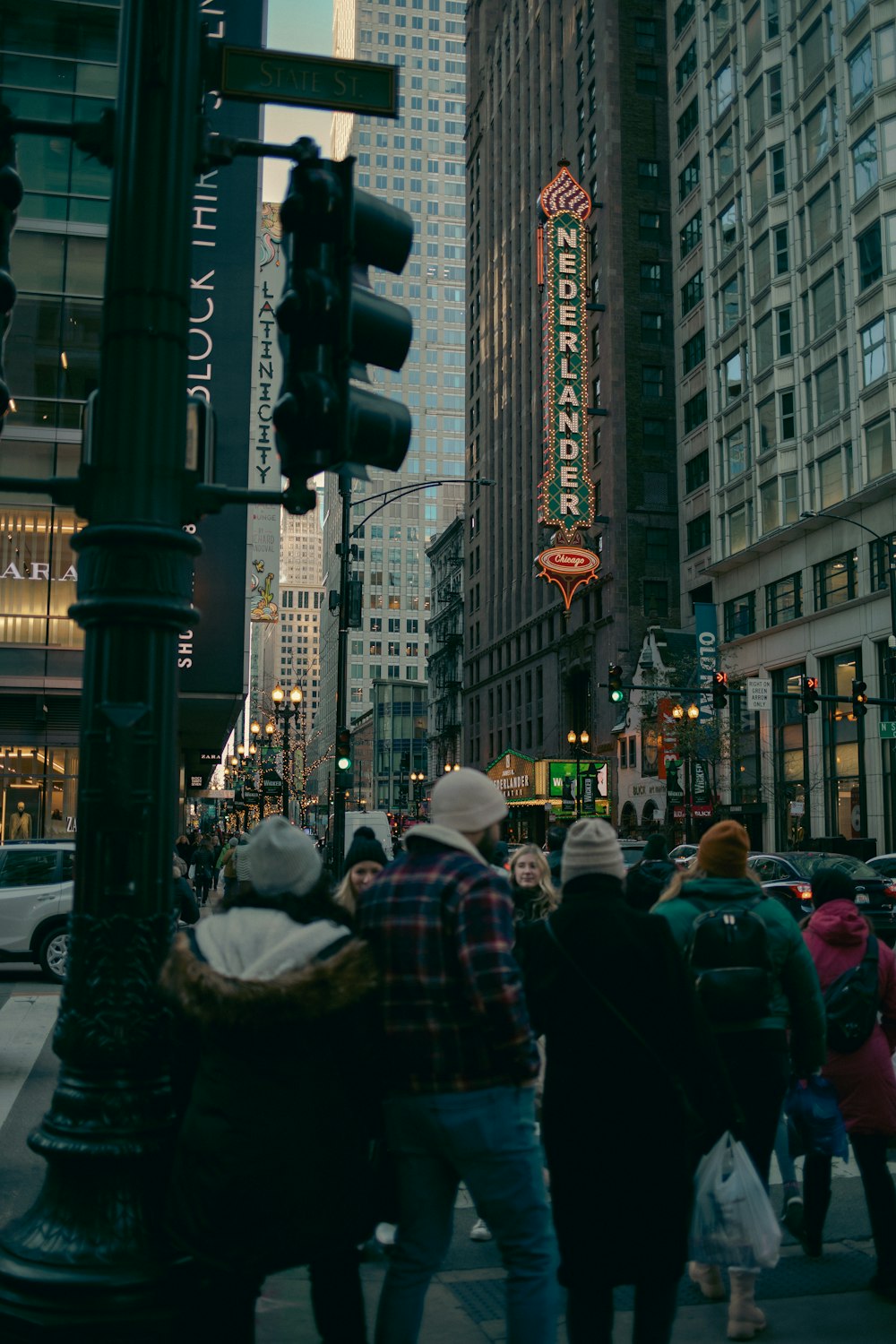 a group of people walking on a busy city street