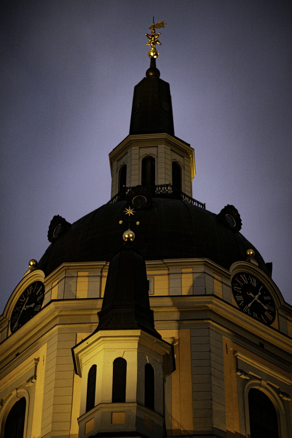 a clock tower with a weather vane