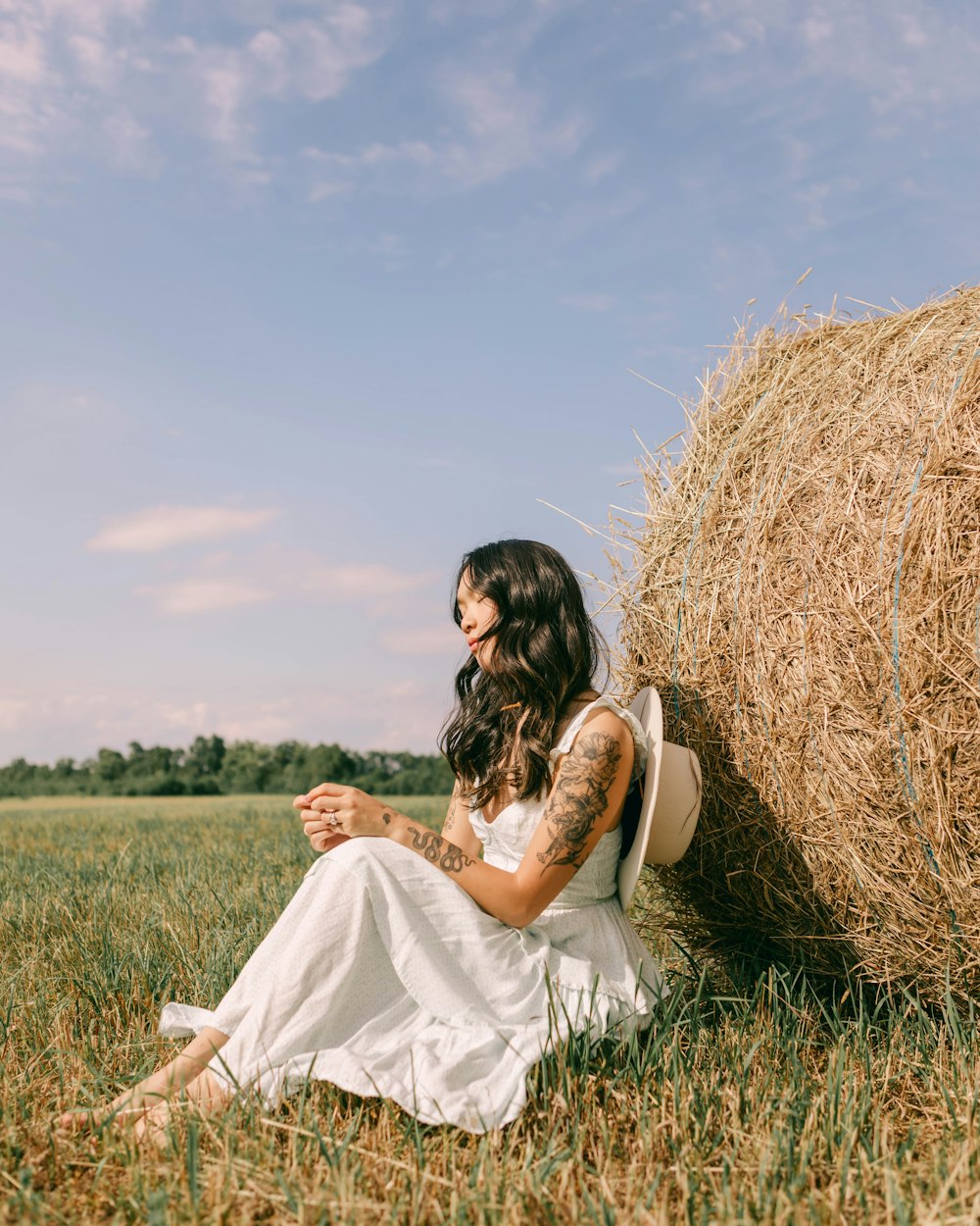 a person sitting in a field of hay
