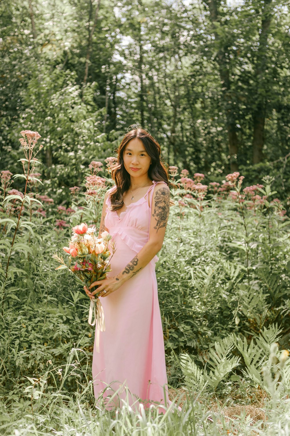 a woman in a dress standing in a garden