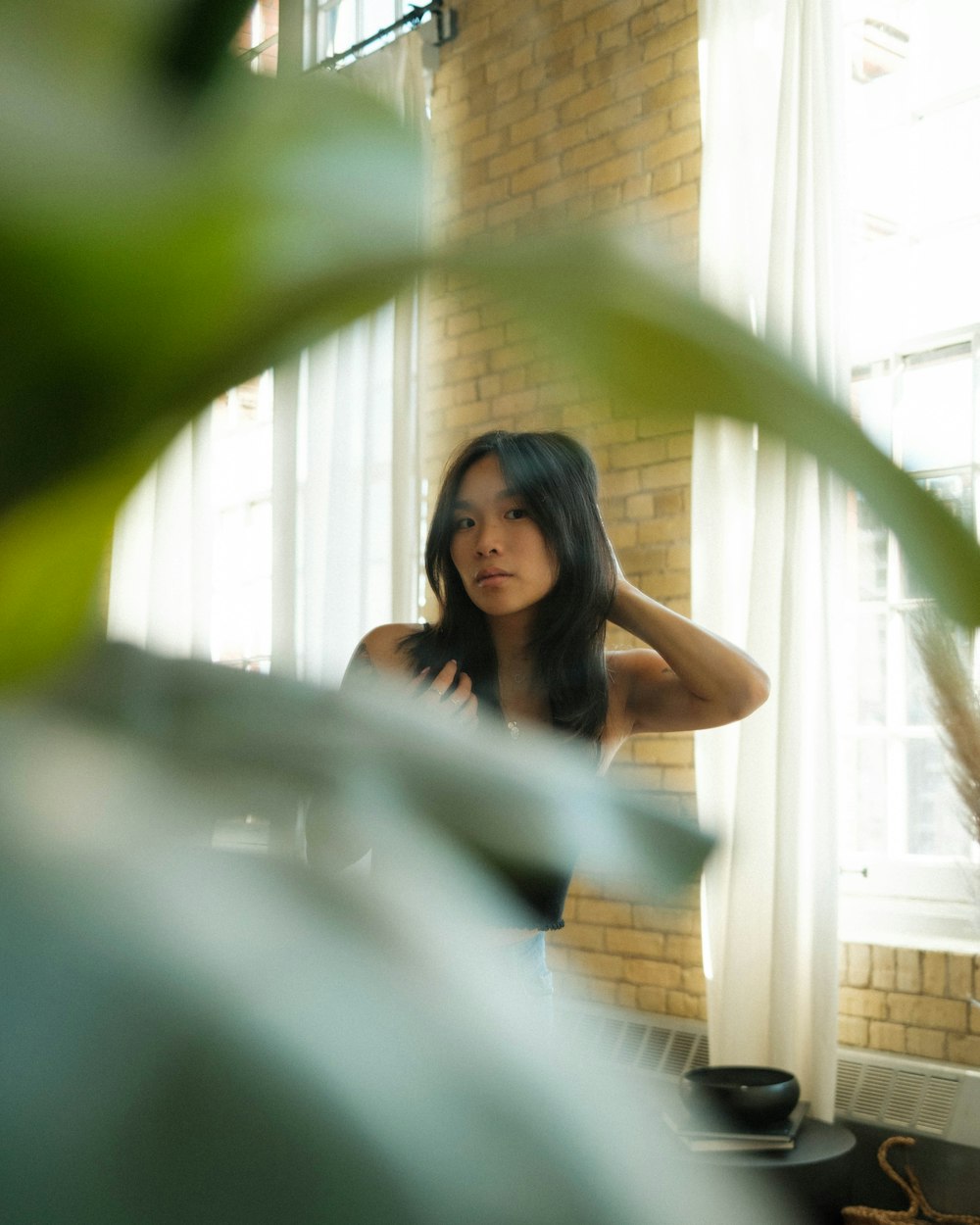 a woman leaning against a window