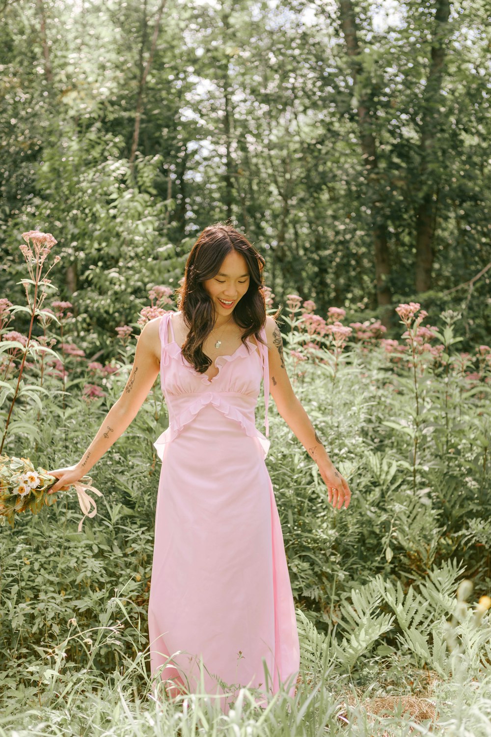 a woman in a dress in a field of flowers