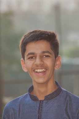 A cheerful Indian child wearing stylish blue jeans from Narayan Kids Wear, playing outdoors in Ahmedabad.