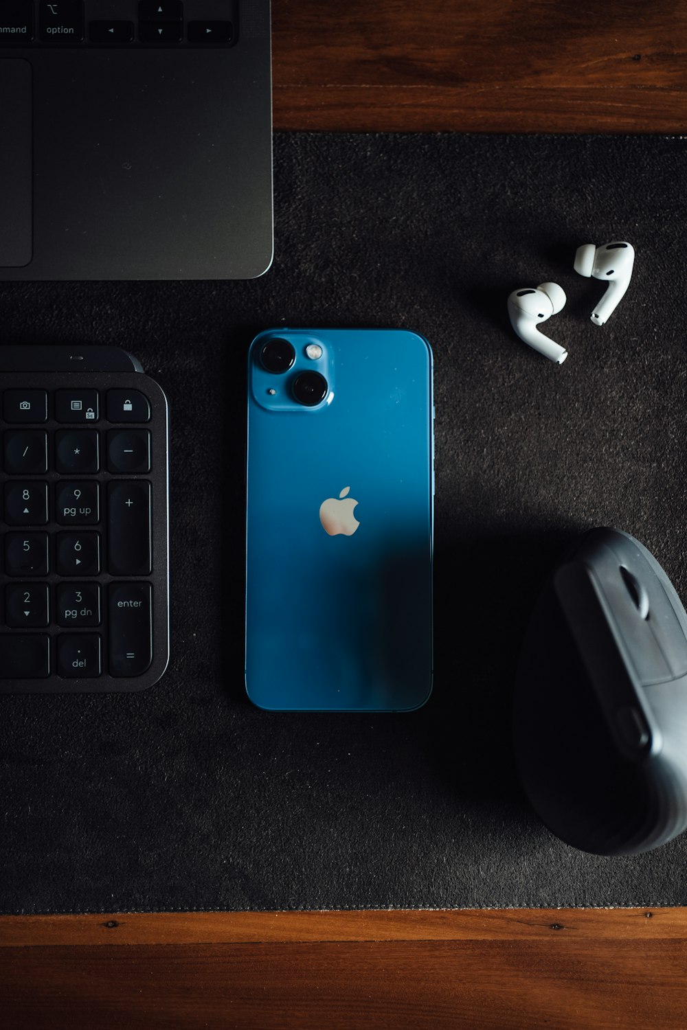 a blue cell phone next to a keyboard and mouse