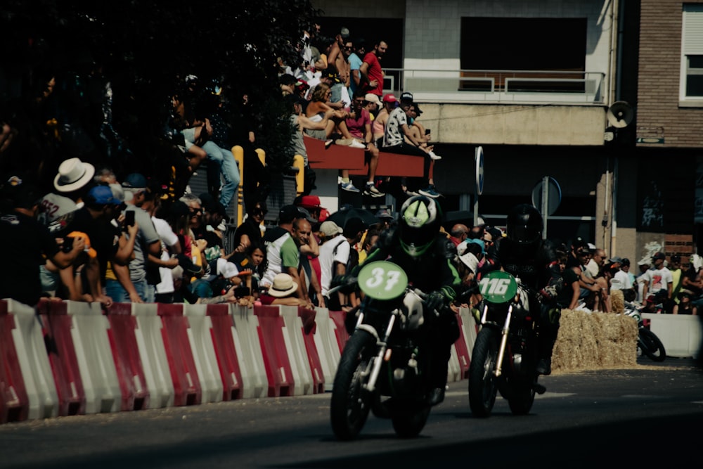 a group of motorcyclists going down a street