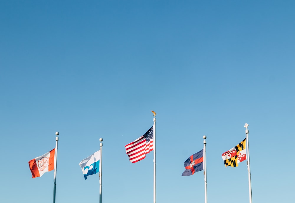 a group of flags on poles