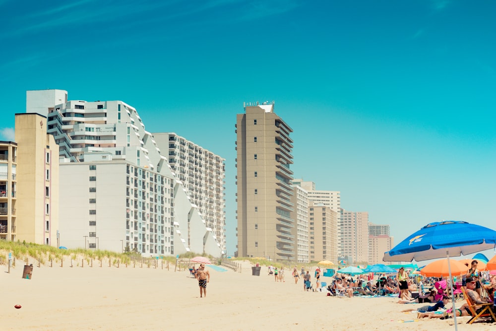 a beach with people and buildings