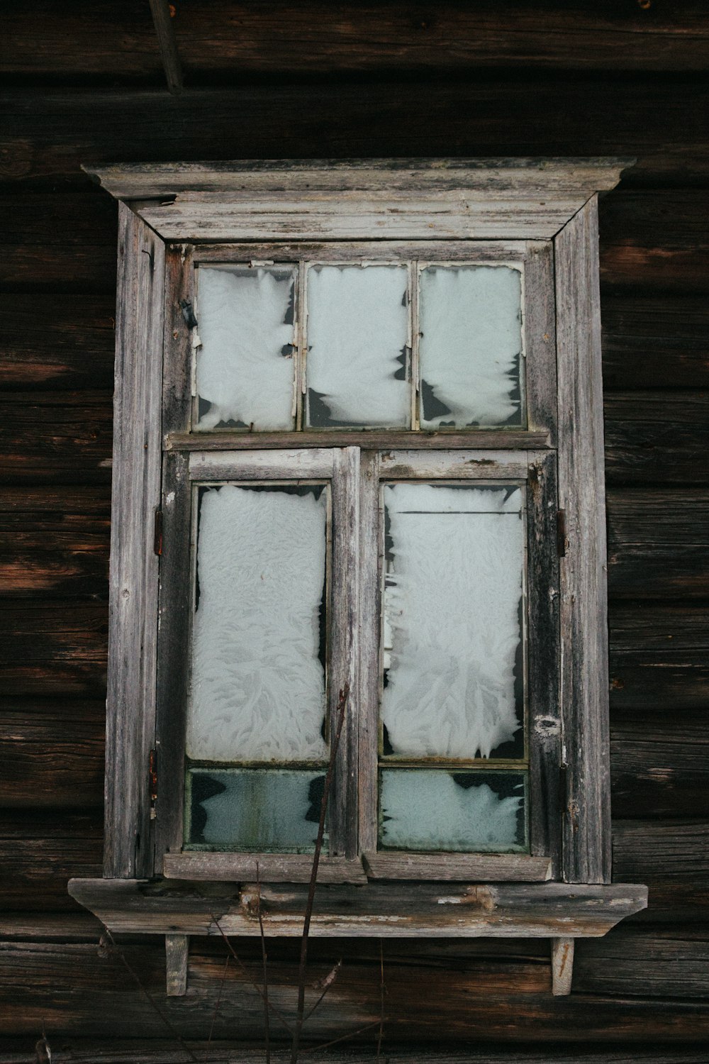 a broken window in a wooden building