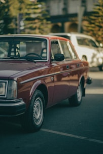 Red sedan front view on a city street