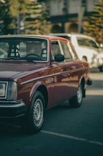 Red sedan front view on a city street