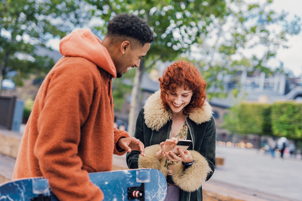 a man and a woman looking at a cell phone