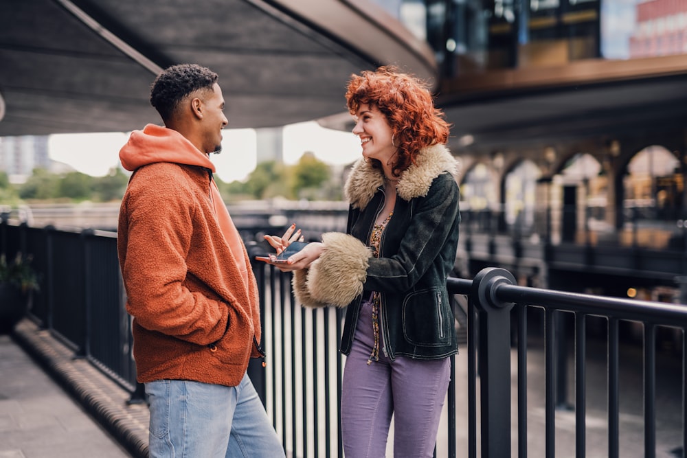 a man and woman looking at a phone