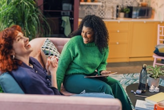A cozy home setting with a couple sharing a laugh over coffee.