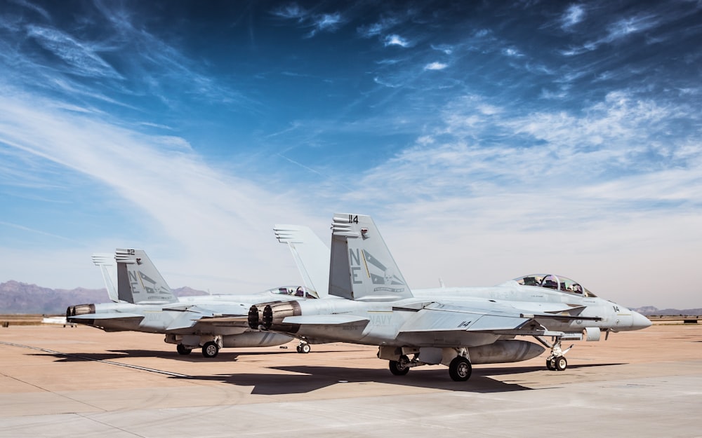 a couple of airplanes on a runway