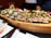 A beautifully arranged platter of assorted sushi rolls on a wooden table.