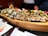 A beautifully arranged platter of assorted sushi rolls on a wooden table.