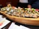 A beautifully arranged platter of assorted sushi rolls on a wooden table.