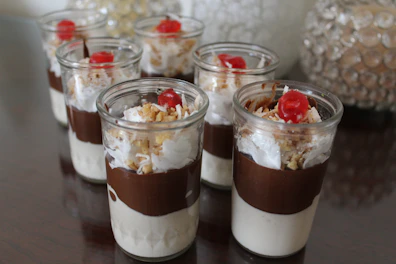 High-resolution image of rich, creamy Mexican desserts in elegant glass cups.