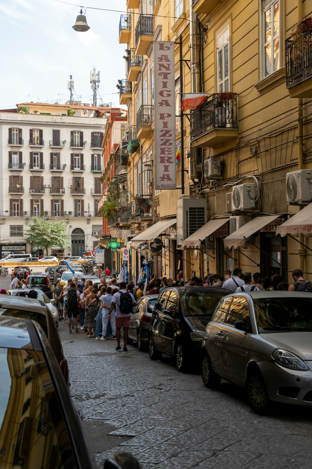 a busy street with cars and people