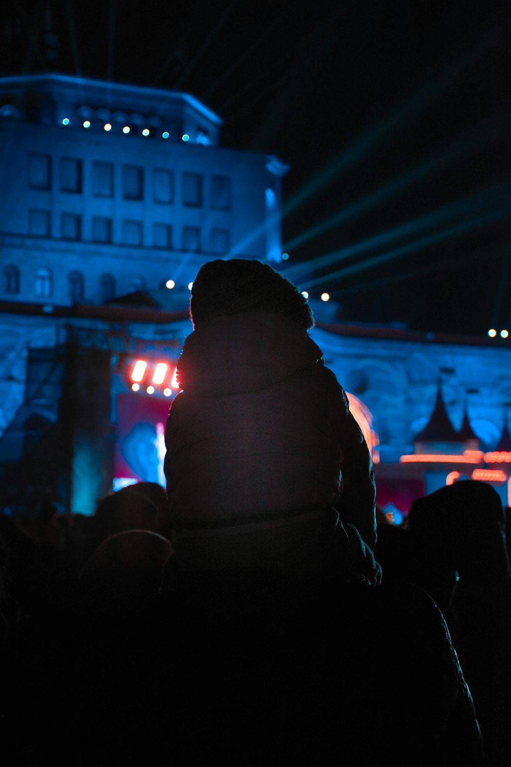 a person standing in front of a building at night