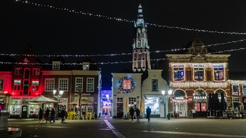 Night view of a lively Mexican town square with festive lights and music.