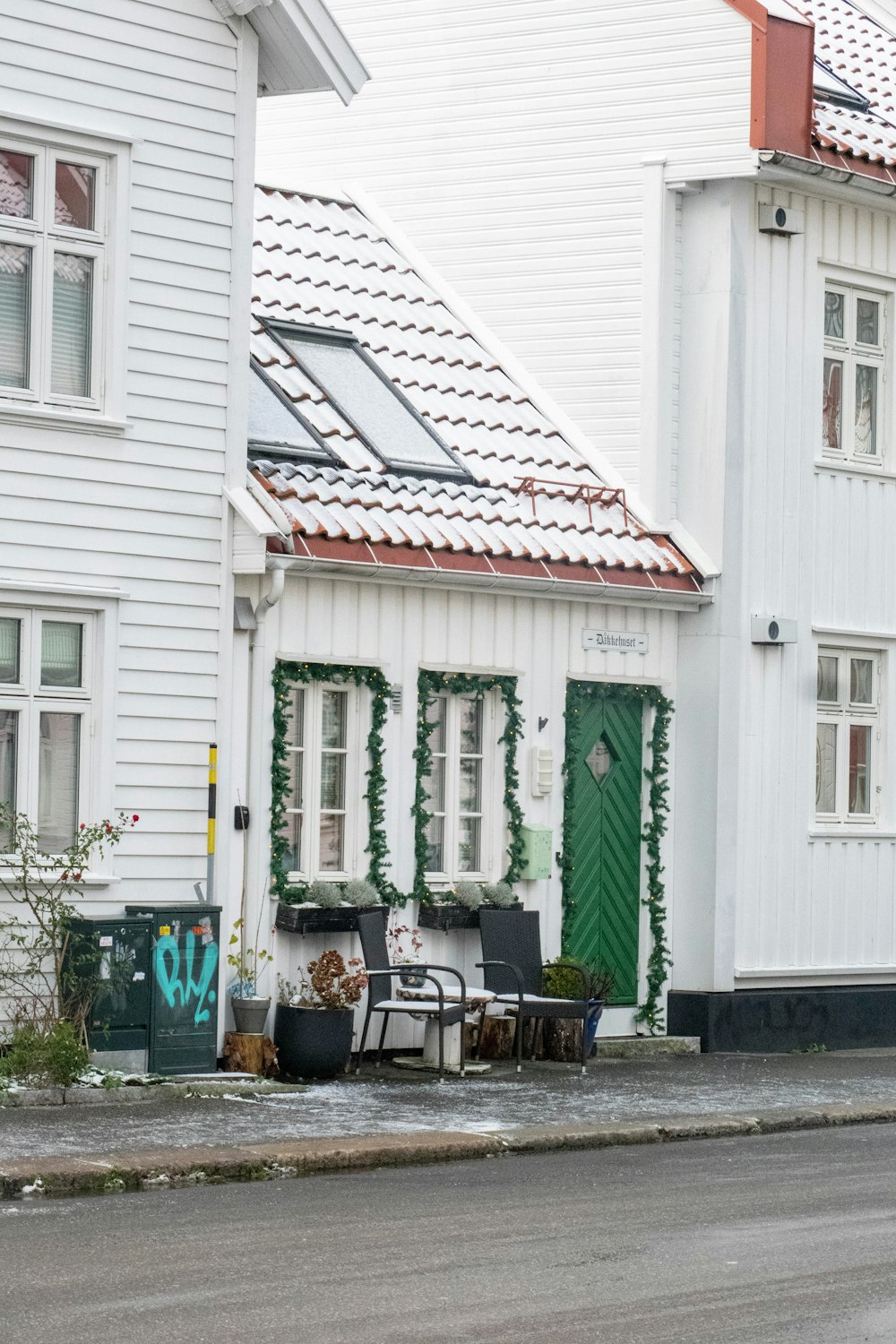 a white house with green doors