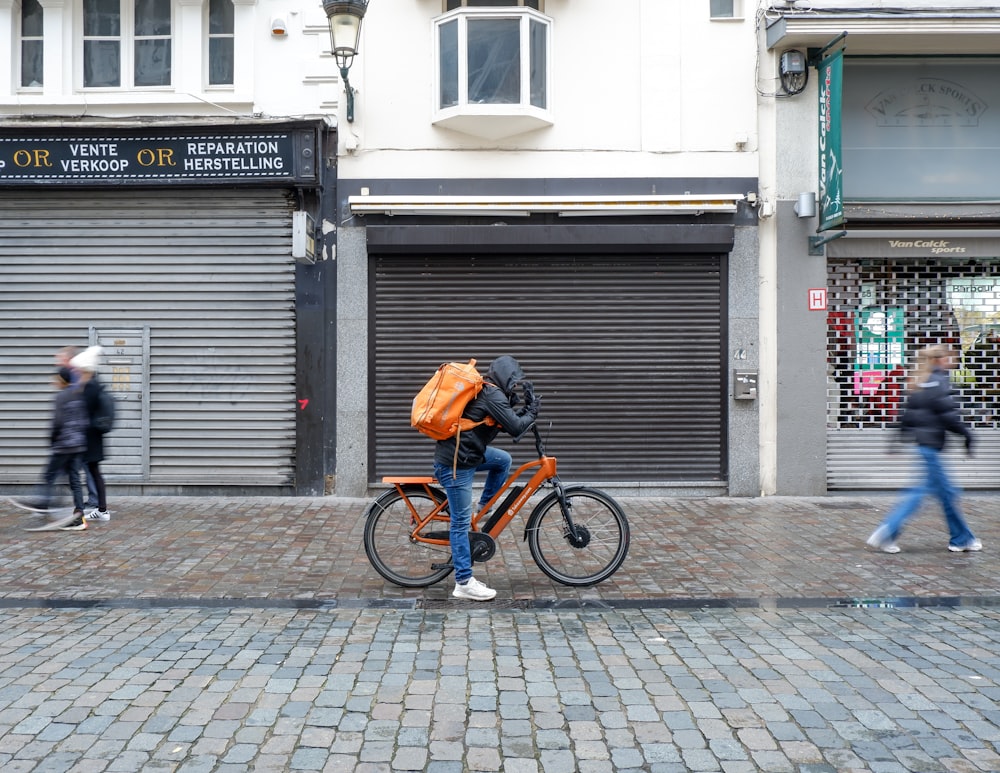 a person riding a bicycle on a sidewalk