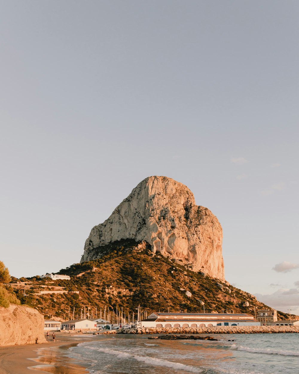 a large rock formation by a body of water