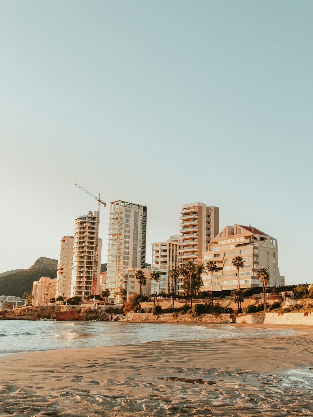 a beach with tall buildings