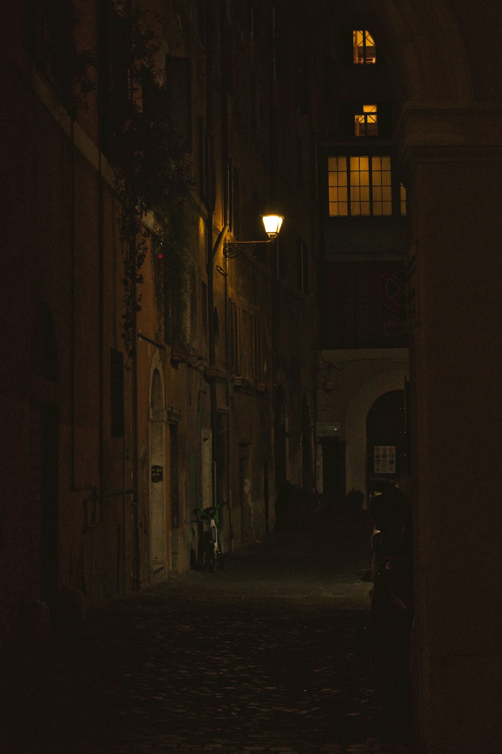 a narrow alley way with a light on