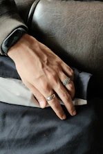 Close-up of elegant leather cuffs resting on a sleek black surface, hinting at intense training sessions.