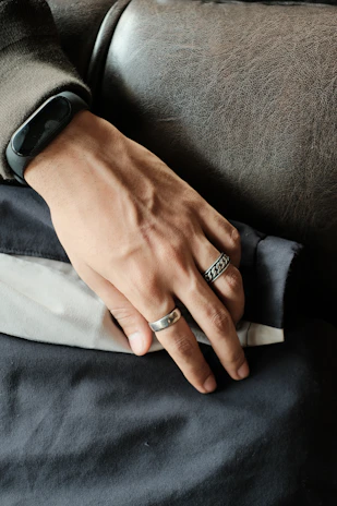Close-up of elegant leather cuffs resting on a sleek black surface, hinting at intense training sessions.