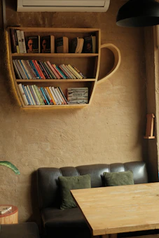 A cozy reading nook with a stack of Arabic books and a warm cup of tea by the window.