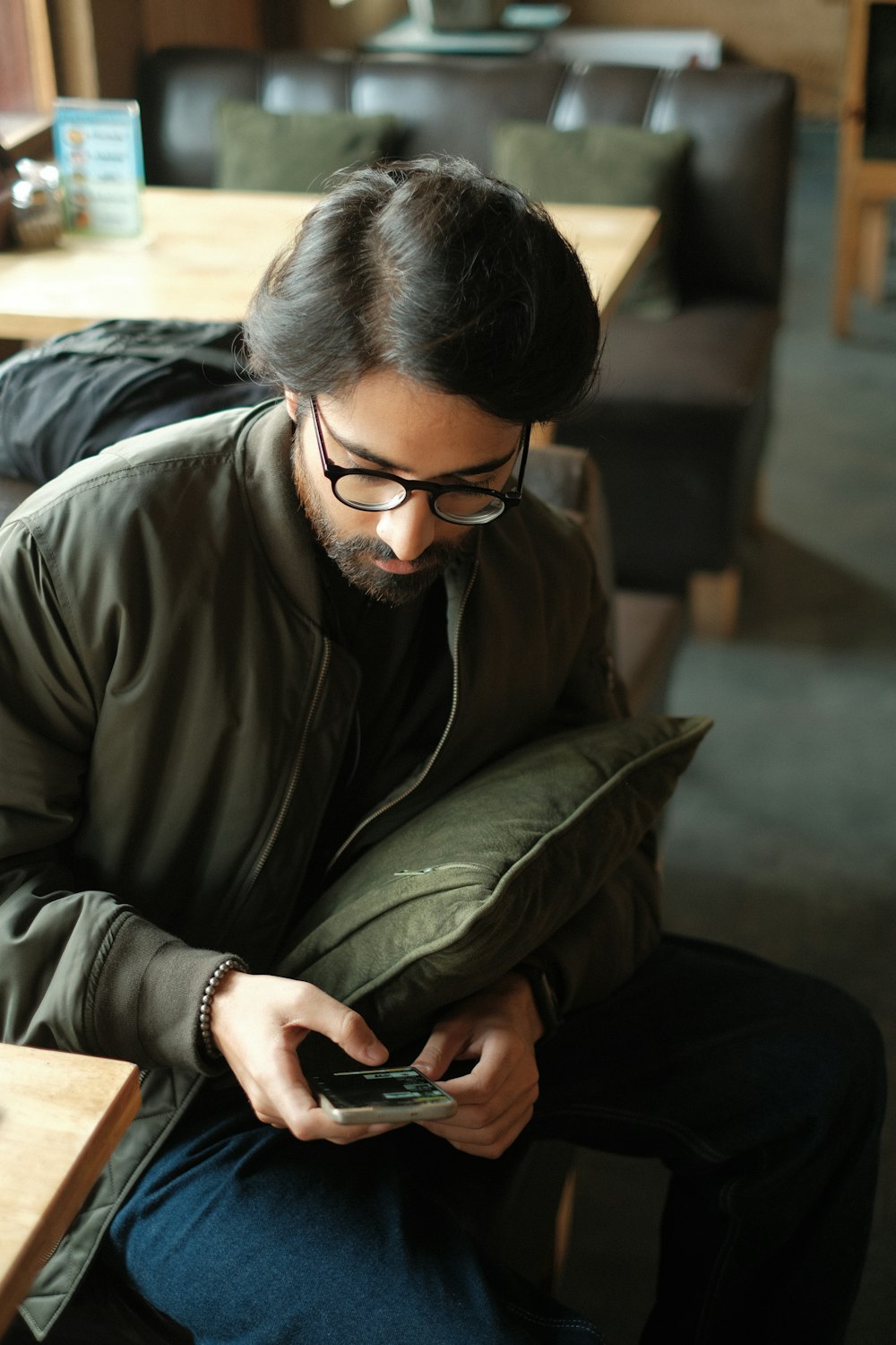 a man sitting on a couch looking at his phone