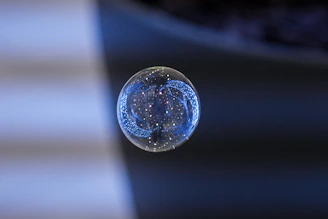 Close-up of a delicate handmade wire wrap bubble wand with shimmering bubbles.