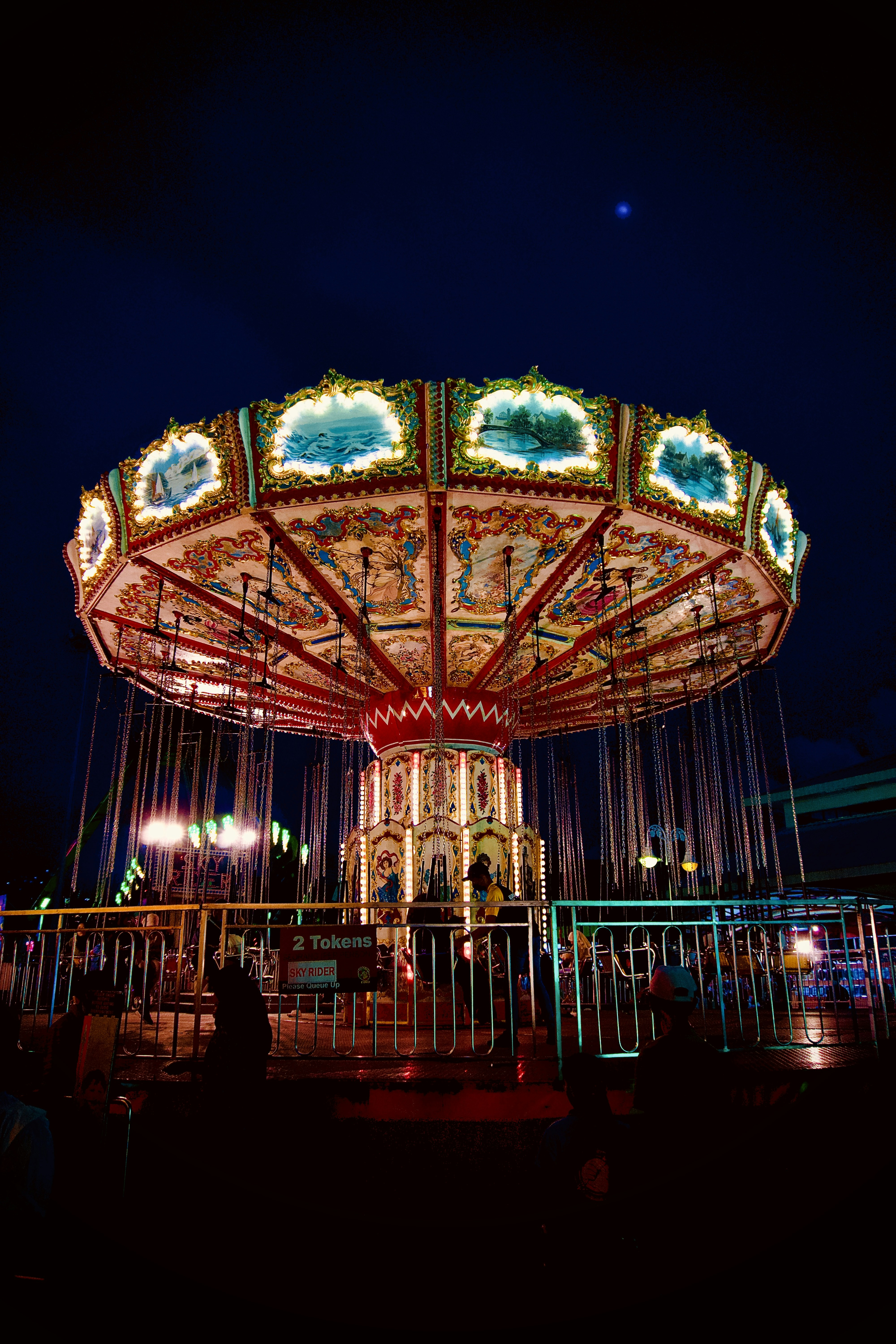 a lit up ferris wheel at night