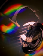 Close-up of translucent glass disc with subtle particle glow and golden-white light bursting from the center.