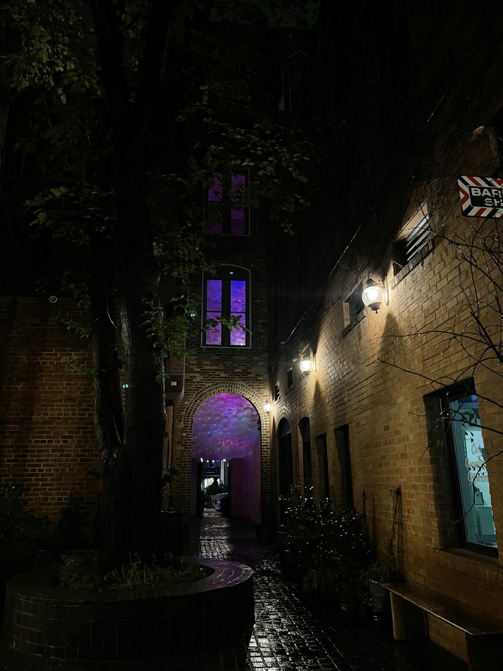 a brick building with a purple archway