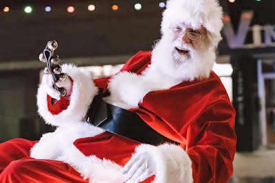 A joyful Santa Claus performing at a festive event in Hong Kong.