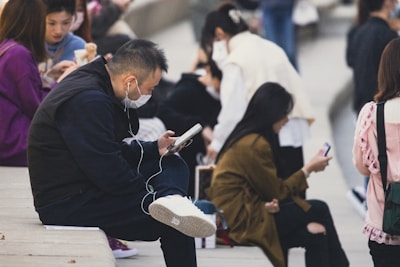 A diverse group of students happily studying online with headphones.