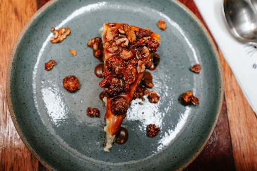 A freshly made Snickers-inspired dessert topped with chopped peanuts and caramel drizzle.